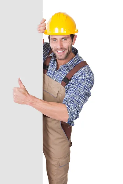 Construction worker presenting empty banner — Stock Photo, Image