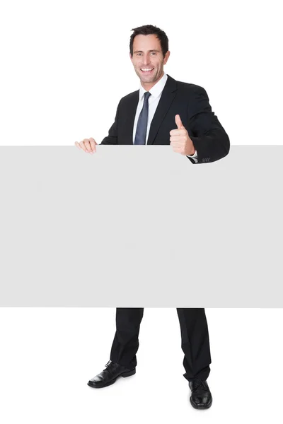 Businessman presenting empty banner — Stock Photo, Image