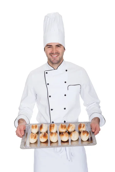 Portrait of happy bakerman with tray — Stock Photo, Image