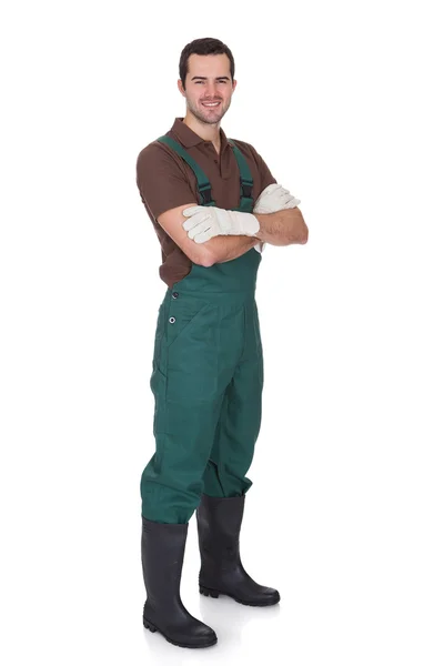 Happy young gardener in dungarees — Stock Photo, Image