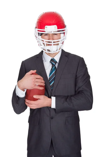 Competitive businessman playing american football — Stock Photo, Image