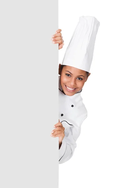 Kobieta kucharz stojąc za afisz — Zdjęcie stockowe