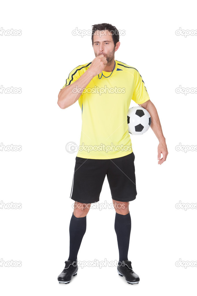 Soccer judge standing with ball