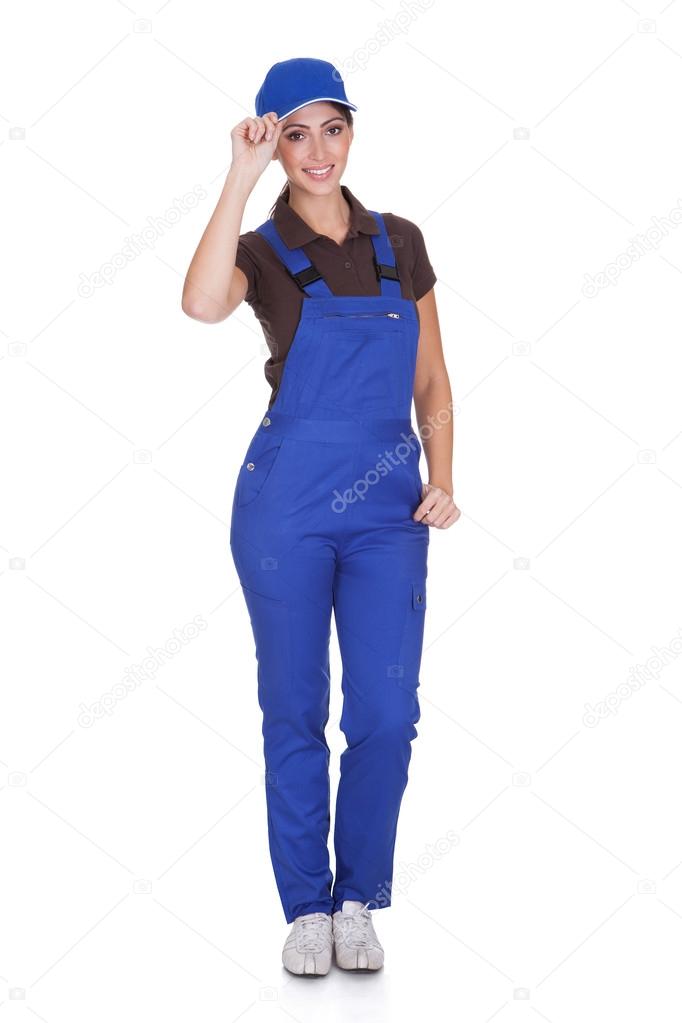 Portrait Of Happy Plumber While Holding Cap
