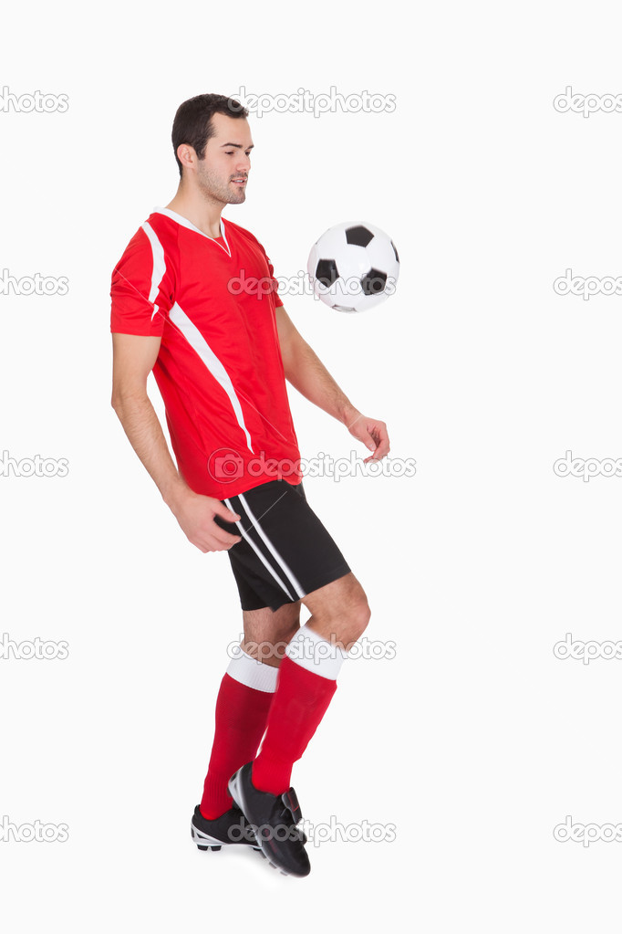 Professional soccer player kicking ball Stock Photo by ©AndreyPopov