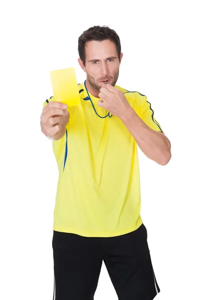 Soccer judge whistling and showing yellow card — Stock Photo, Image