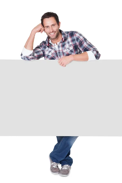 Happy middle age man presenting empty banner — Stock Photo, Image