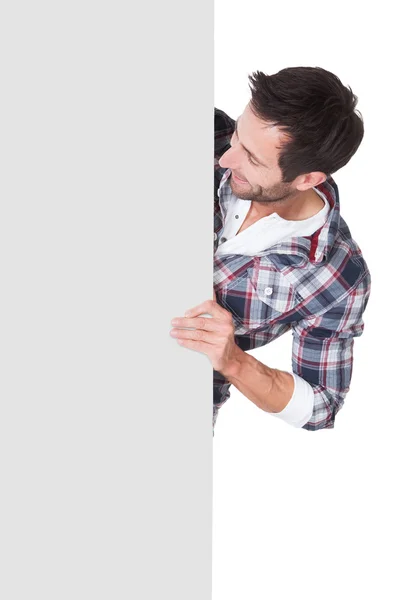 Happy middle age man presenting empty banner — Stock Photo, Image