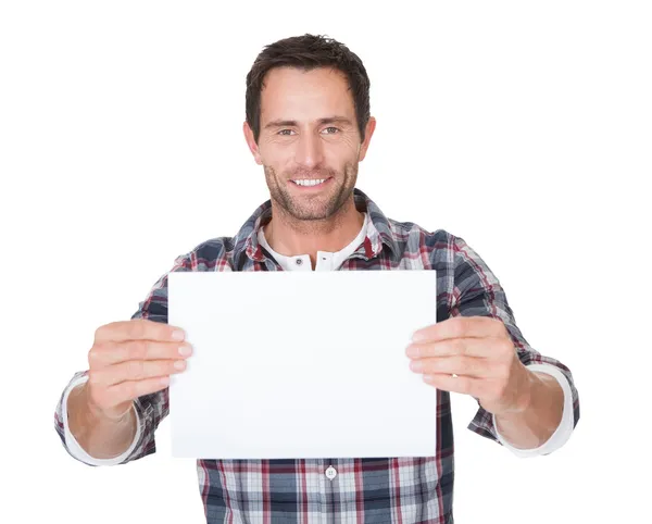 Happy middle age man presenting empty paper — Stock Photo, Image