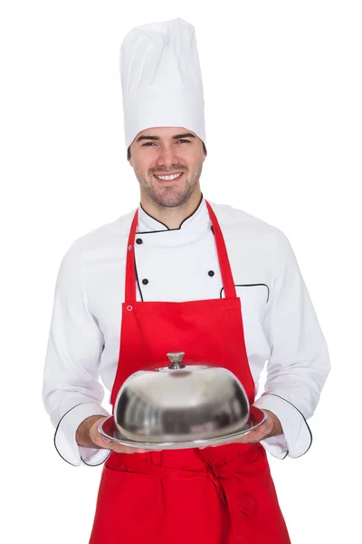 Portrait of cheerful chef with silver tray — Stock Photo, Image