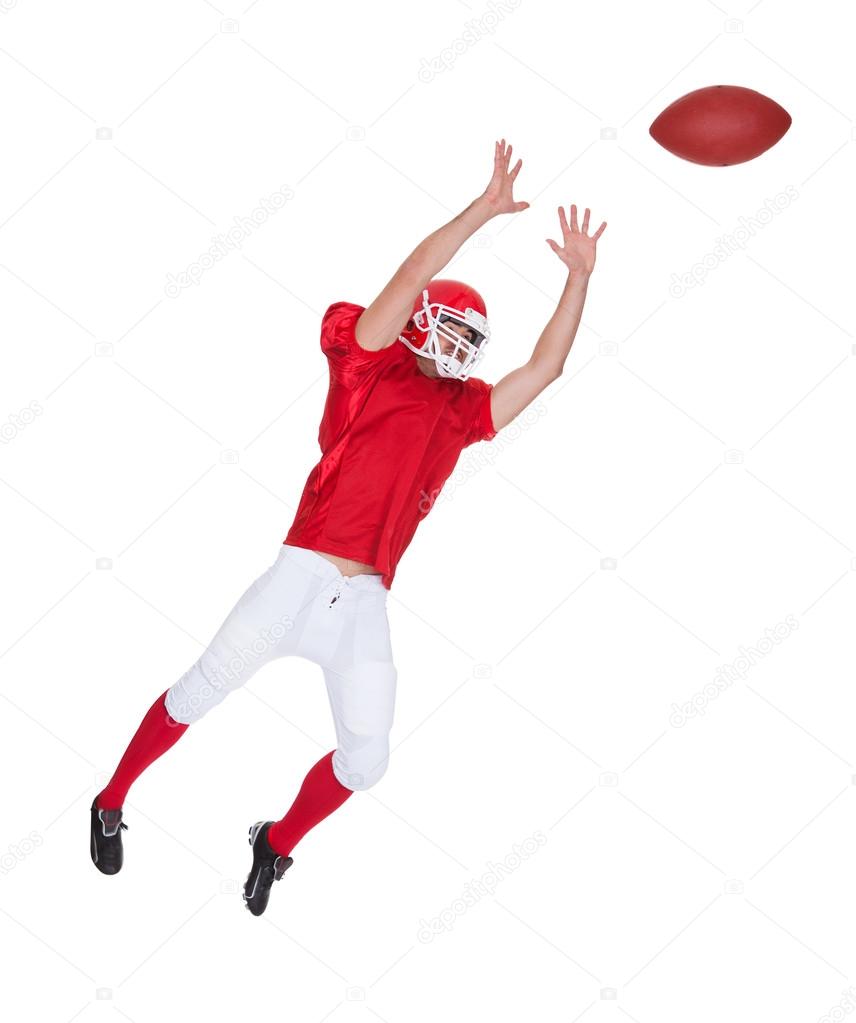 American Football player catching ball