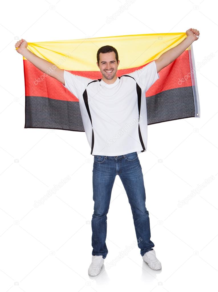 Portrait Of A Happy Man Holding An German Flag