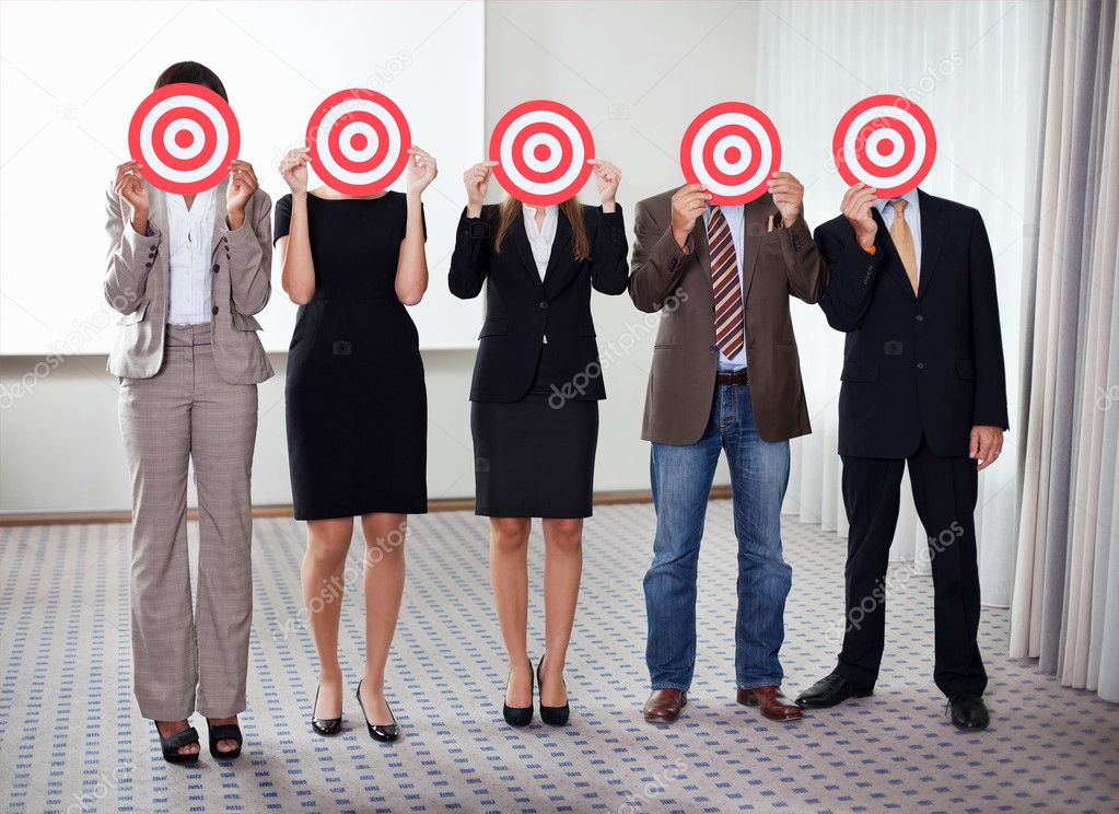 Group of business holding a target
