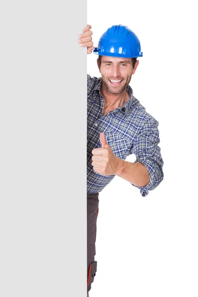 Portrait of happy worker presenting empty banner — Stock Photo, Image