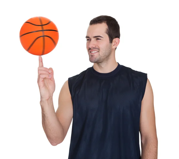 Professional basketball player spinning ball — Stock Photo, Image