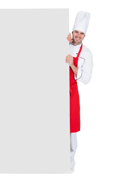 Chef em uniforme apresentando banner vazio — Fotografia de Stock
