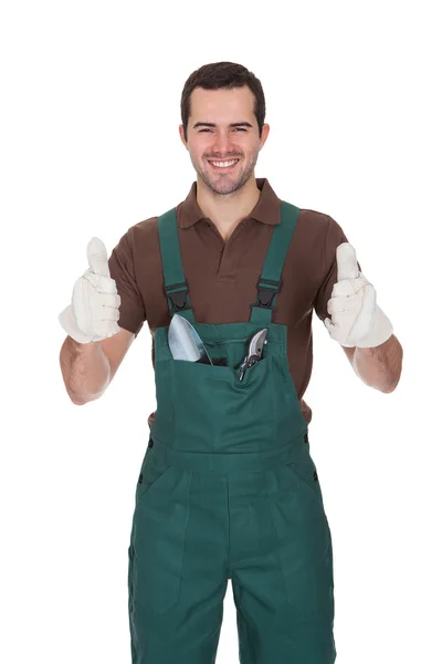 Happy young gardener in dungarees — Stock Photo, Image