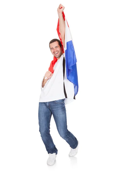 Homem feliz segurando uma bandeira da Holanda — Fotografia de Stock