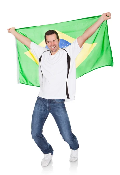 Retrato de un hombre feliz sosteniendo una bandera brasileña — Foto de Stock