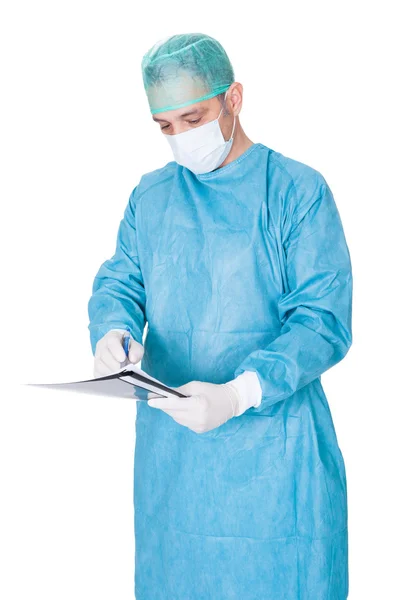 Doctor In Operation Gown Writing On Folder — Stock Photo, Image