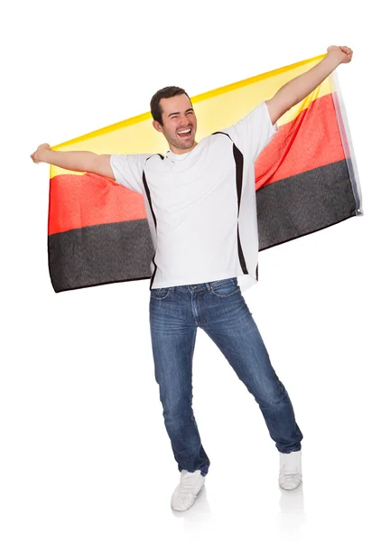 Retrato de un hombre feliz sosteniendo una bandera alemana —  Fotos de Stock