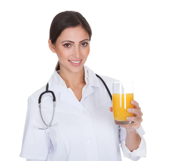 Happy Female Doctor Holding Orange Juice — Stock Photo, Image