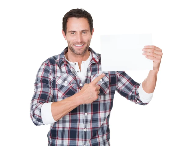 Happy middle age man presenting empty paper — Stock Photo, Image