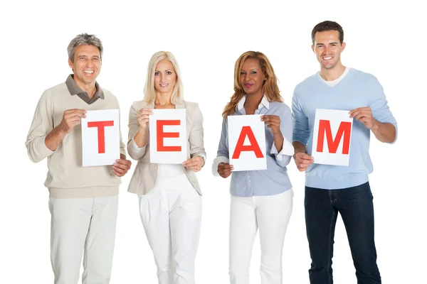 Happy group of holding team sign board — Stock Photo, Image