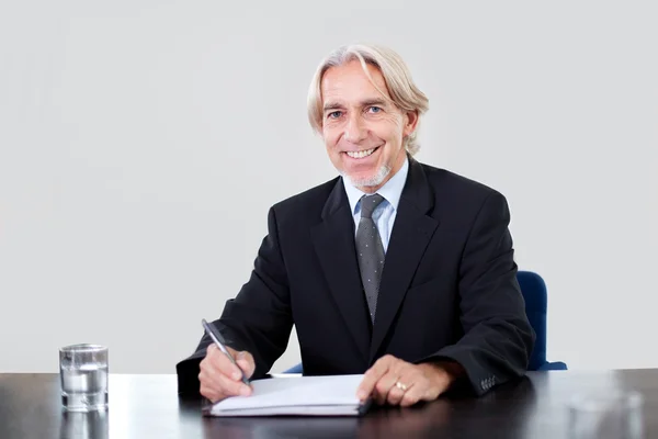 Portrait of a happy mature businessman working — Stock Photo, Image