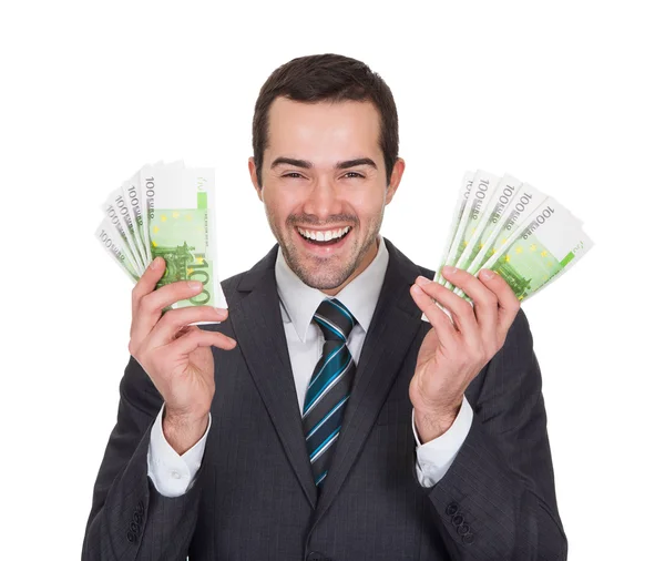 Excited businessman holding euro notes — Stock Photo, Image