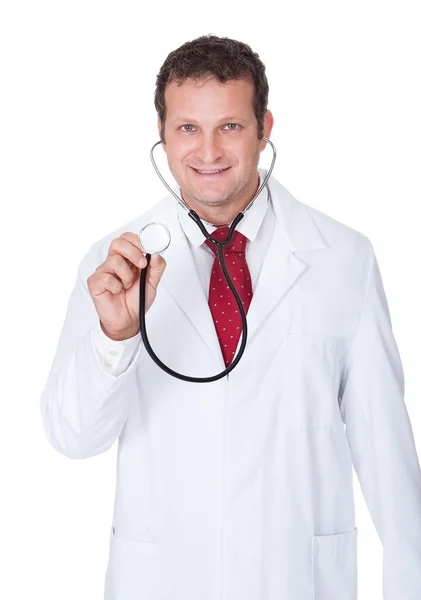 Confident doctor using stethoscope Royalty Free Stock Images
