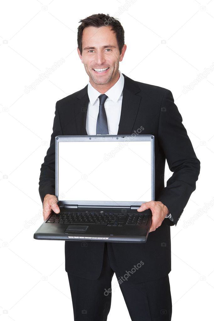 Happy middle aged businessman with laptop