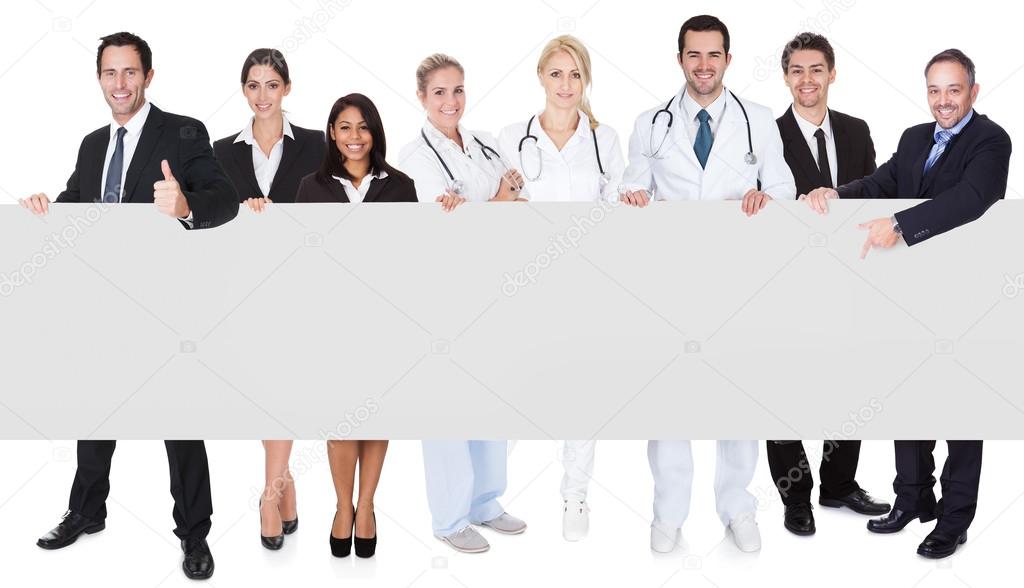 Doctors and managers presenting empty banner