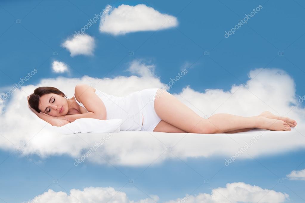 Young Woman Sleeping On Clouds