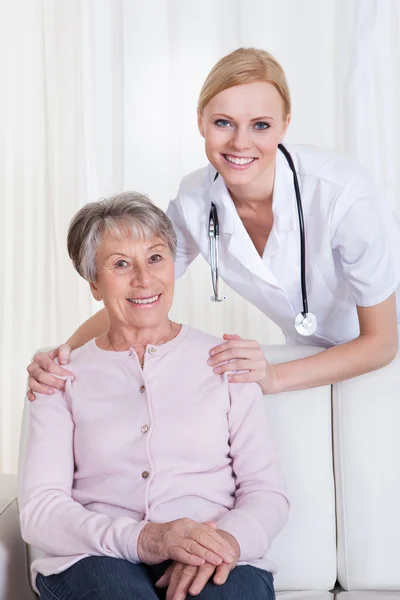 Retrato del médico y el paciente sentado en el sofá — Foto de Stock