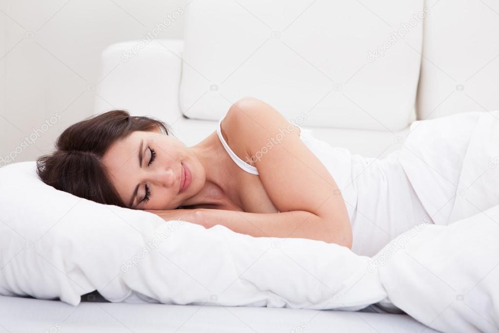 Young Woman Sleeping On The Bed