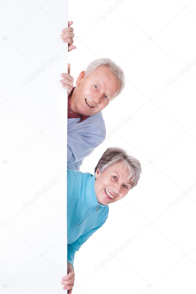 Senior Couple Holding Blank Placard