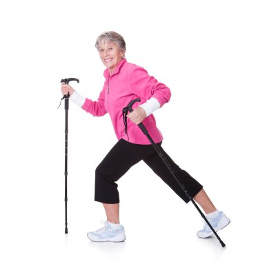 Senior Woman Walking With Hiking Poles