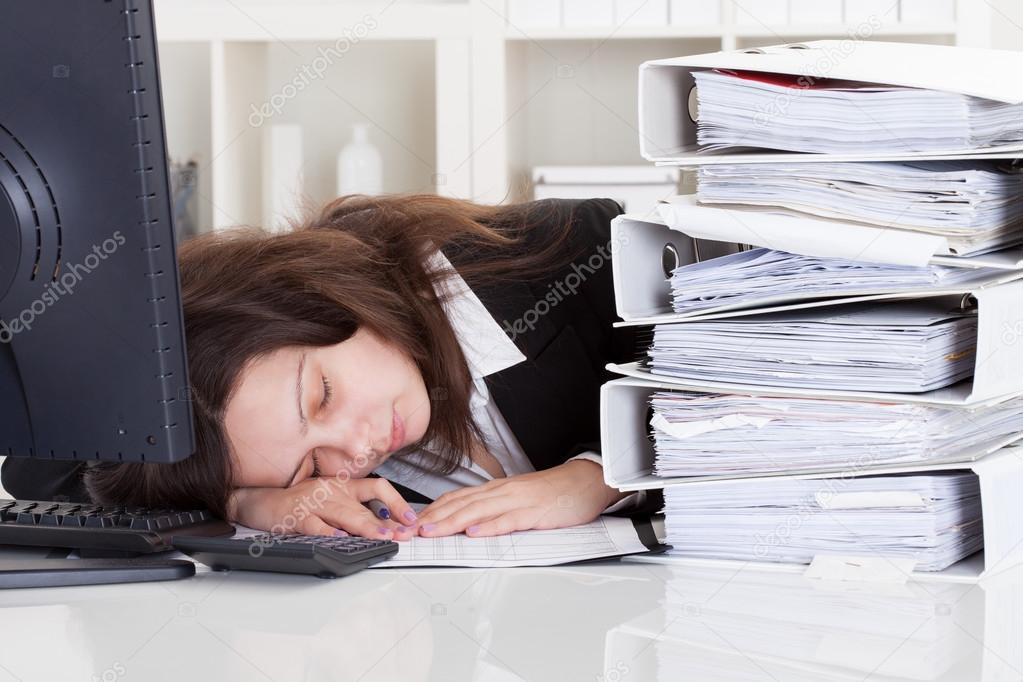 Stressed Woman Sleeping In Office