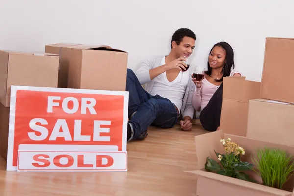 Couple Sitting Among Boxes Making Celebration — Stock Photo, Image