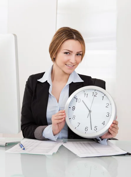 Businesswoman Holding Clock Stock Picture