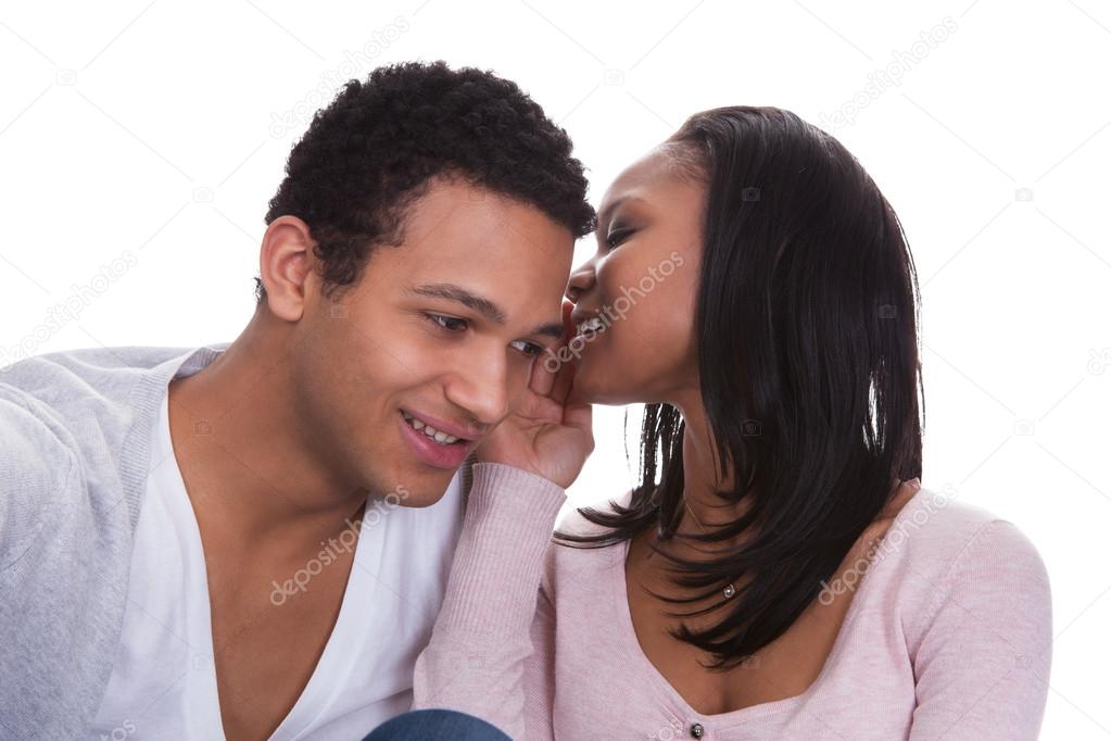 Woman Whispering To Boyfriend's Ear