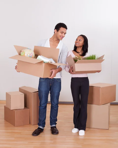 Couple Carrying Boxes In House