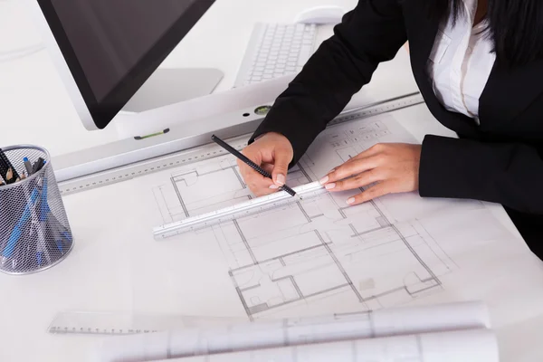 Close-up Of Female Architect Drawing Blueprint Royalty Free Stock Photos