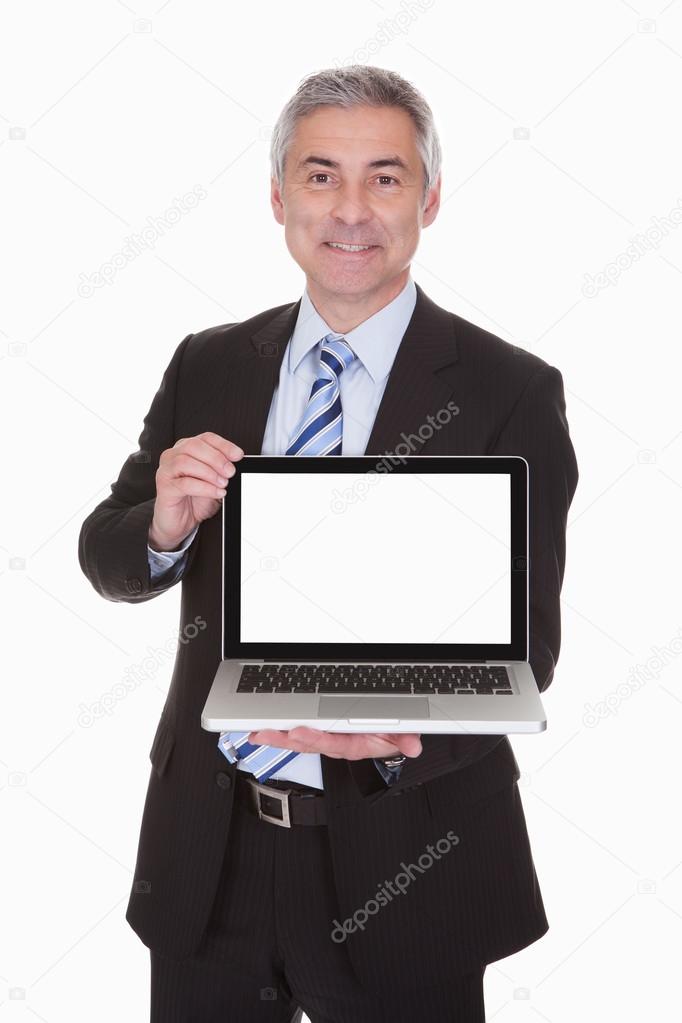 Happy Mature Businessman Presenting Laptop
