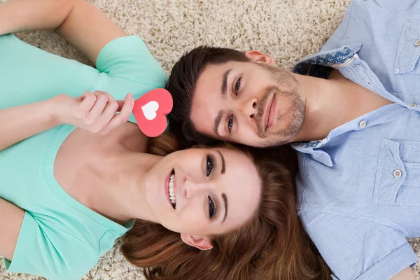 Glückliches junges Paar auf dem Rücken liegend — Stockfoto