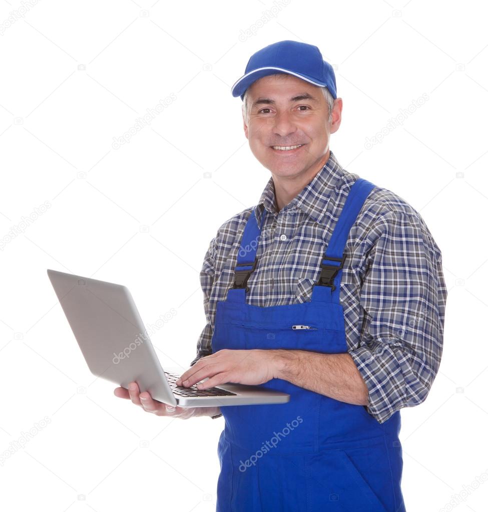 Mature Male Technician Using Laptop