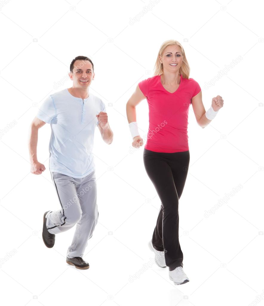 Fitness couple running towards camera