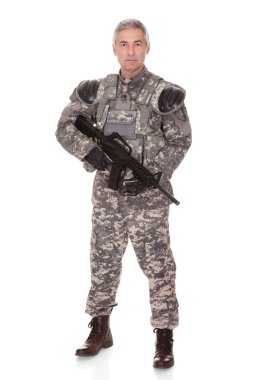 Mature Soldier Holding Rifle clipart