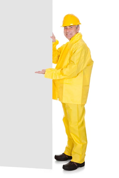 Mature Man Wearing Raincoat And Standing Behind Placard — Stock Photo, Image